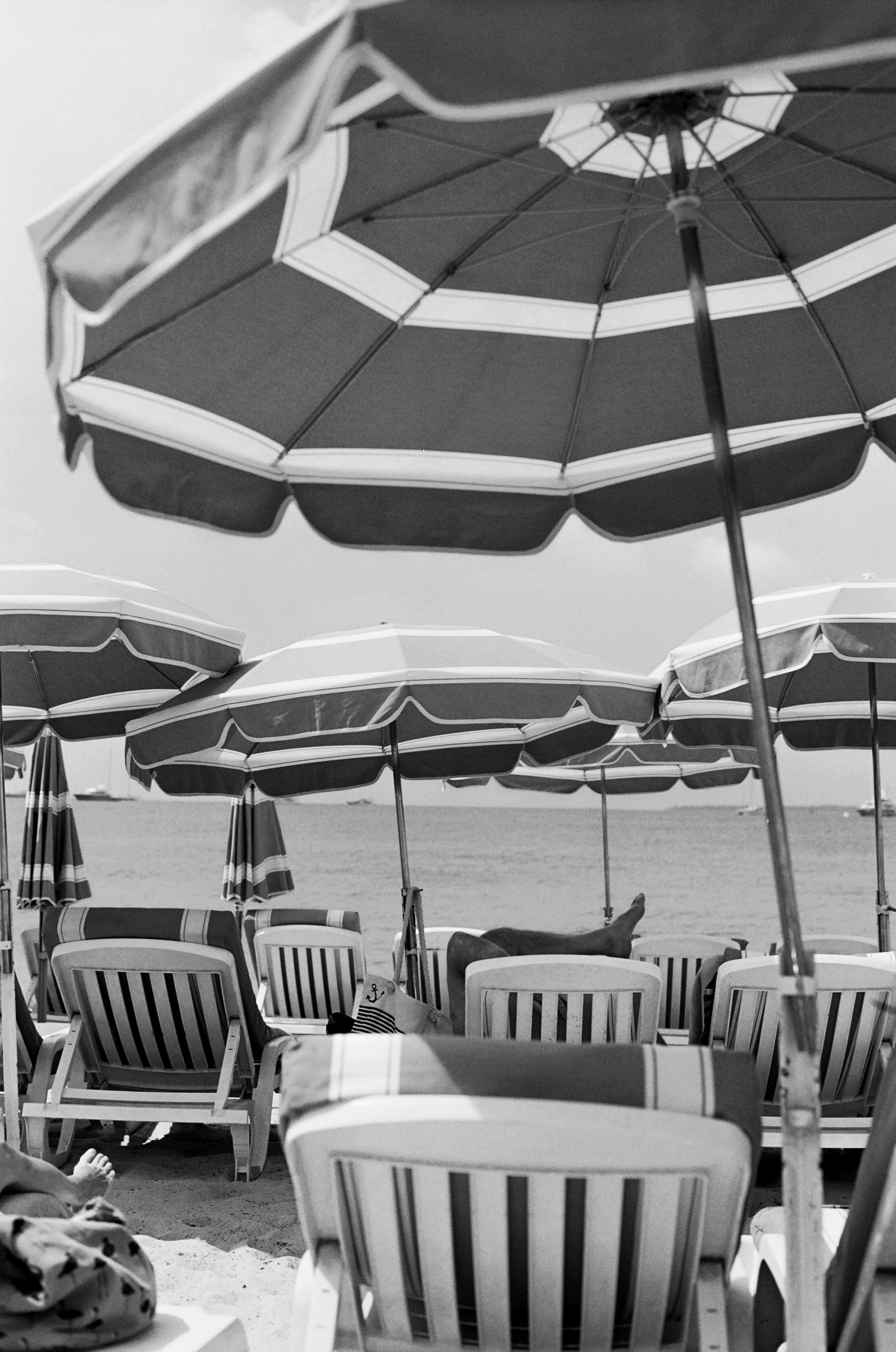 Photograph of sunlounges and umbrellas on Antibes beach in the Cote D'Azur in France.