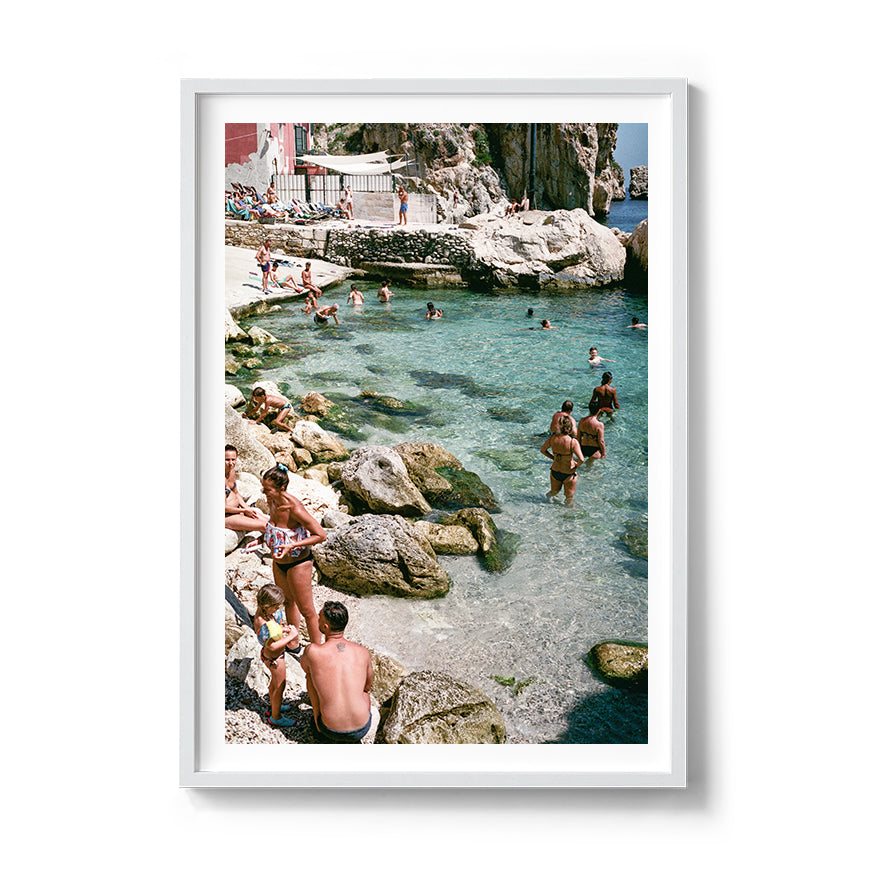 Sara's 'Sicilian Swimming Hole' print framed in a white timber frame.